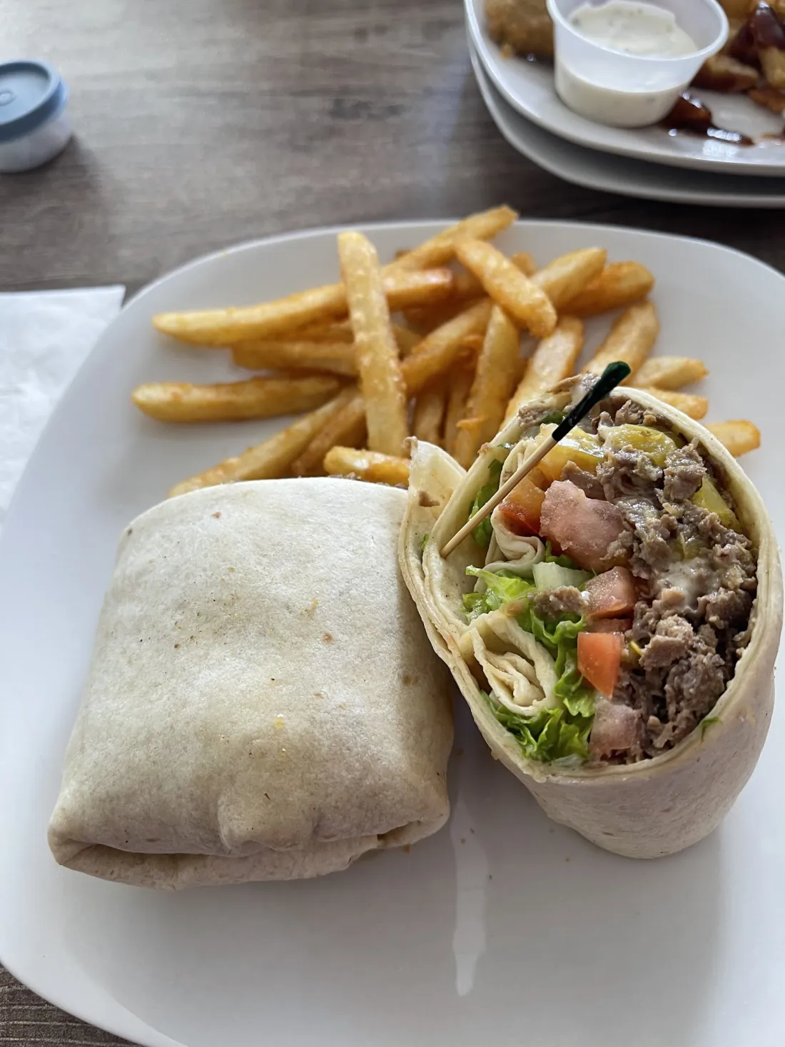 Stella's cheesesteak wrap served with a side of fries