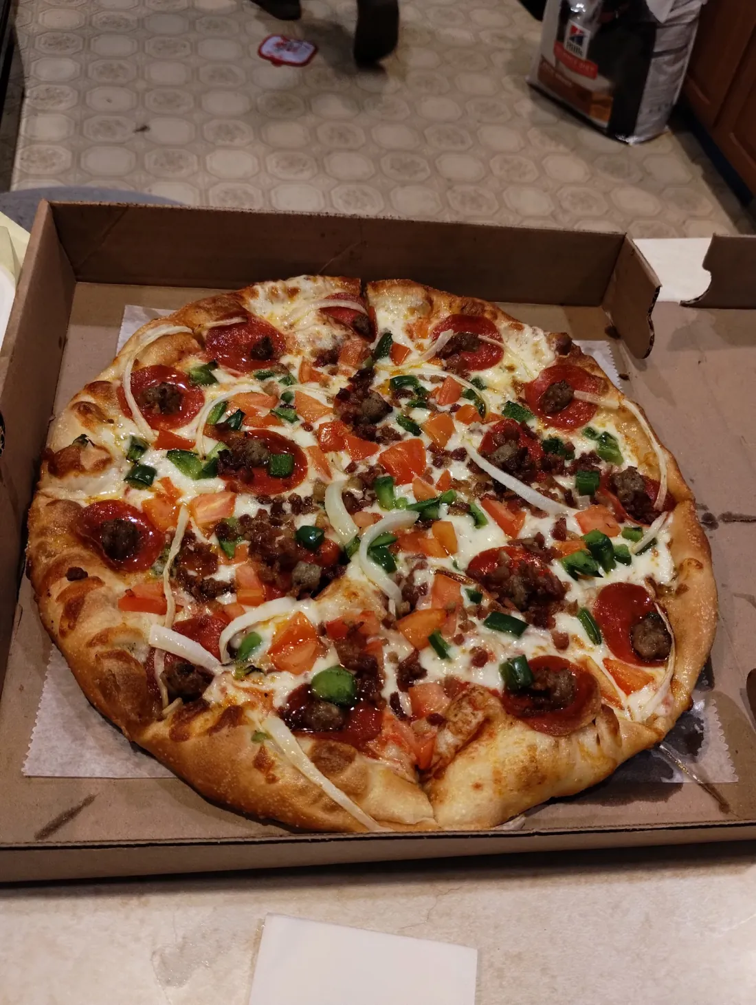 Loaded supreme pizza with pepperoni, sausage, peppers and onions