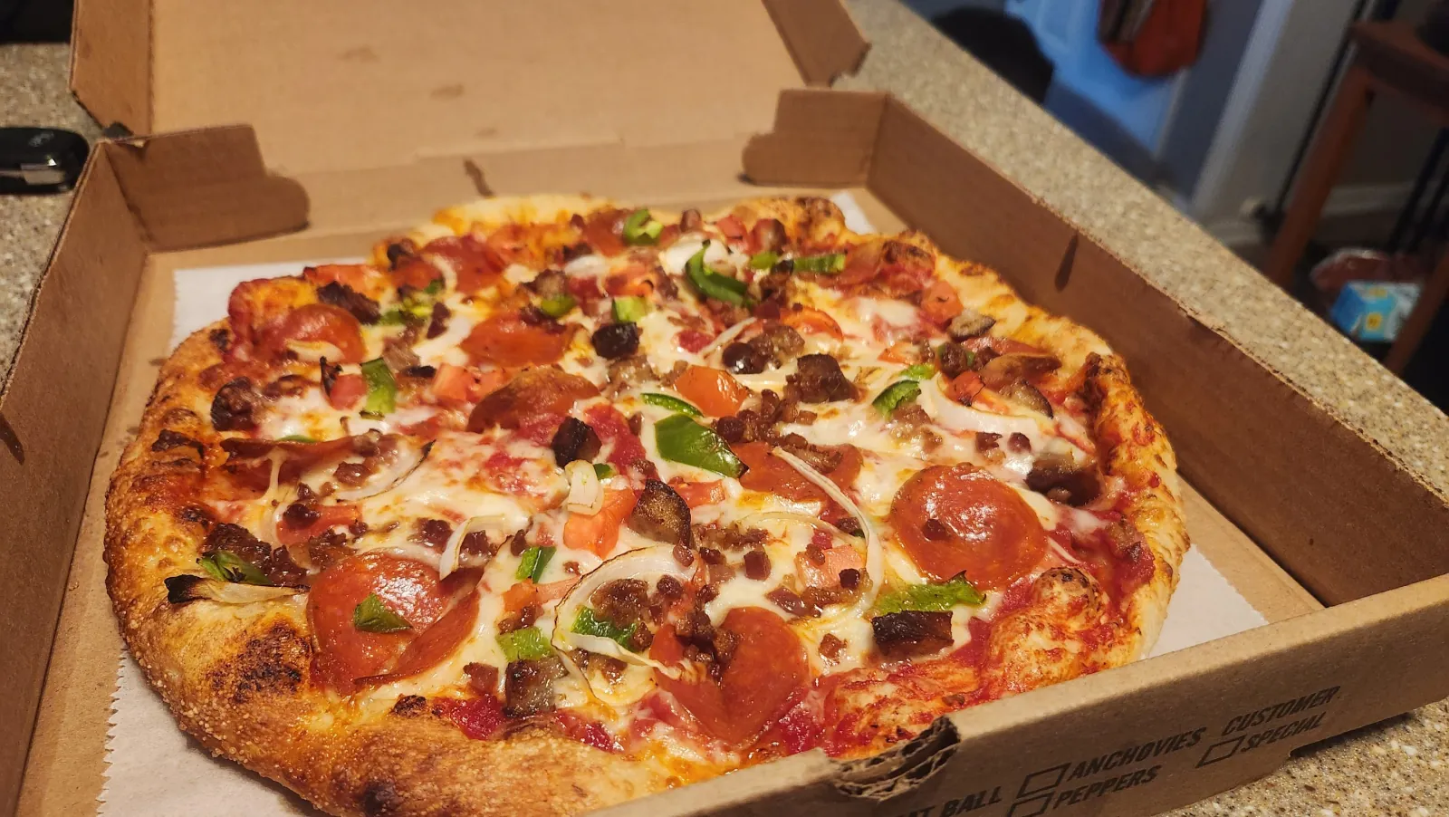 Stella's hand-tossed supreme pizza loaded with pepperoni, sausage, peppers and onions